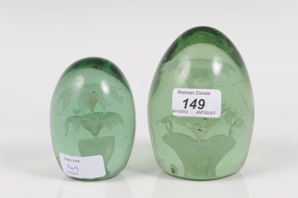 Two Victorian green Stourbridge glass desk weights with internal floral and bubble decoration,