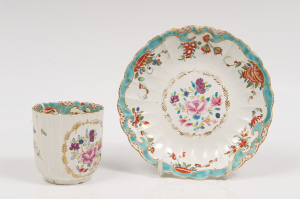 Mid-eighteenth century Worcester fluted cup and saucer with polychrome painted floral sprig and