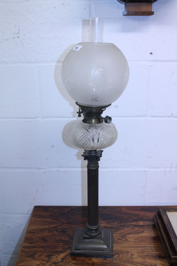 Victorian brass oil lamp with cut glass reservoir supported by a column on square base with a