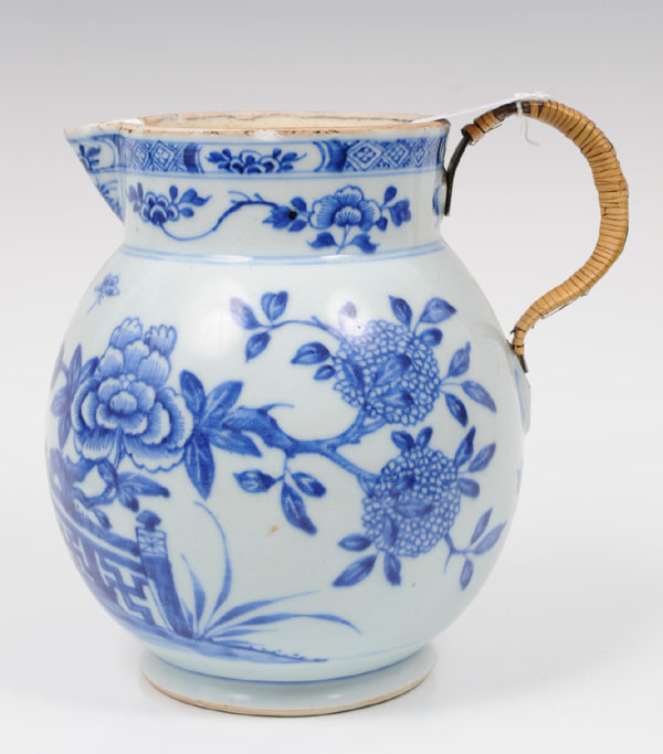 Mid-eighteenth century Chinese export blue and white jug with painted floral and fence decoration,