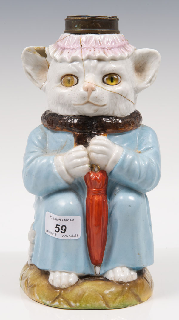 Late nineteenth century German porcelain novelty oil lamp base, in the form of a cat wearing a fur-