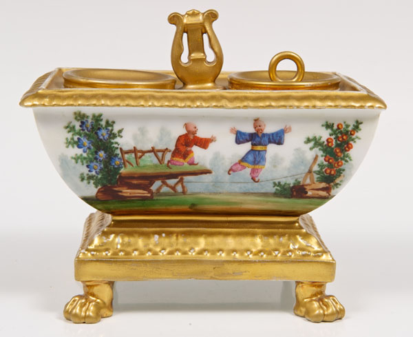 Early nineteenth century Paris porcelain inkstand of sarcophagus form with central lion handle,