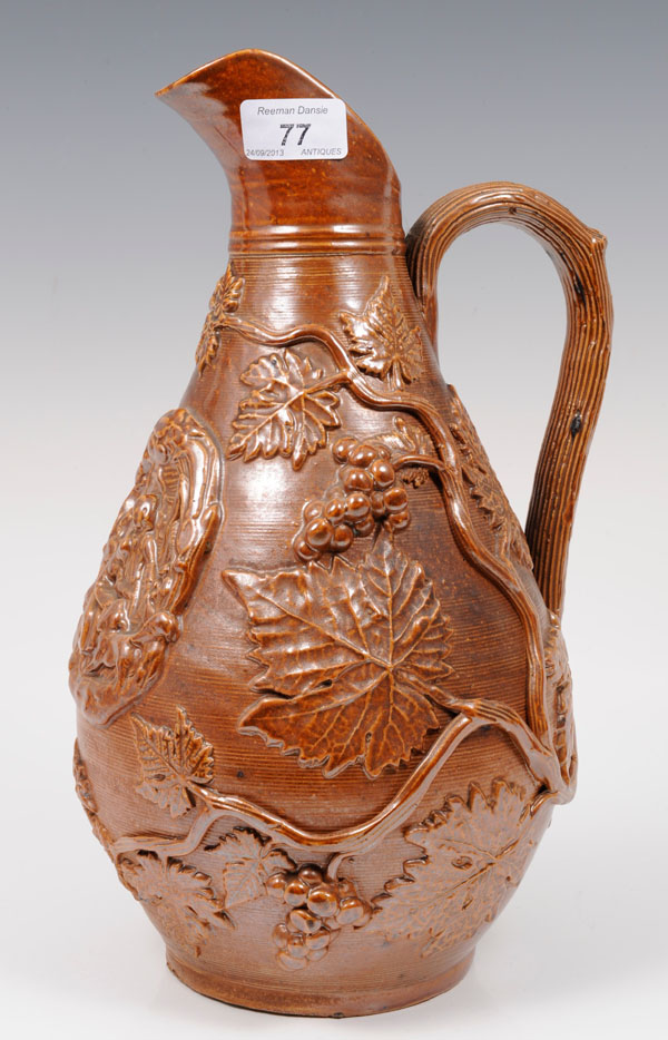 Nineteenth century brown salt-glazed pottery jug with applied romantic scene and grapevine