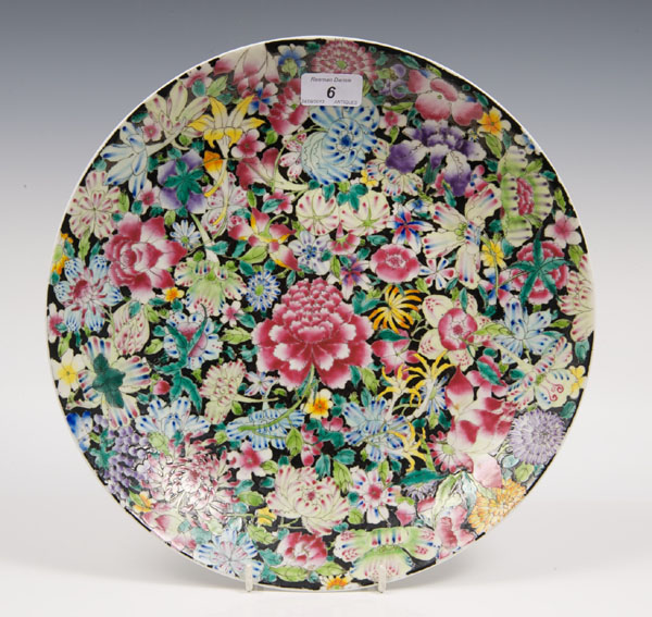 Chinese famille noire porcelain dish with polychrome floral decoration and red seal mark to base,