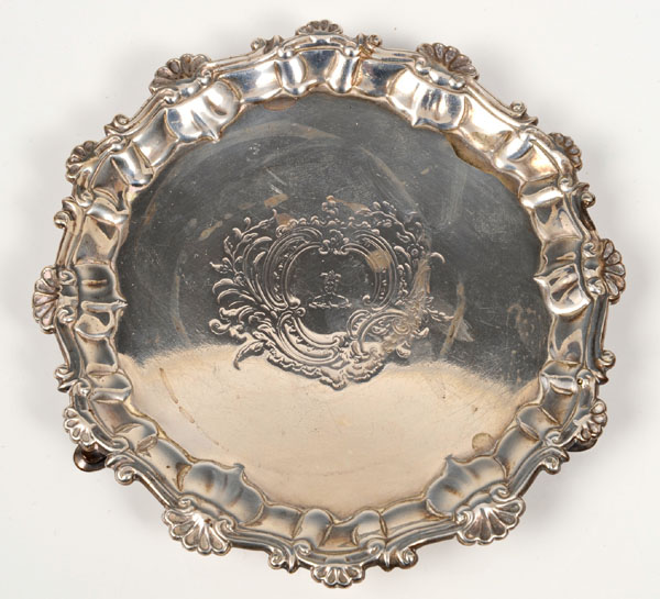 George II silver card tray of circular form with piecrust border and shell and scroll rim, central