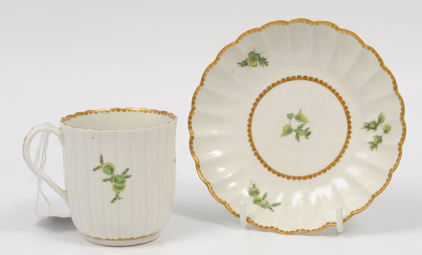 Eighteenth century Worcester fluted porcelain cup and saucer with green painted floral sprigs and