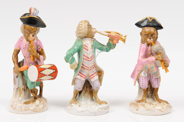 Three nineteenth century German porcelain monkey band figures including trumpeter, drummer and