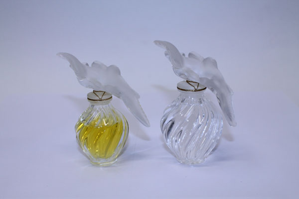 Two contemporary Lalique scent bottles with bird stoppers and a boxed set of three Lalique scent