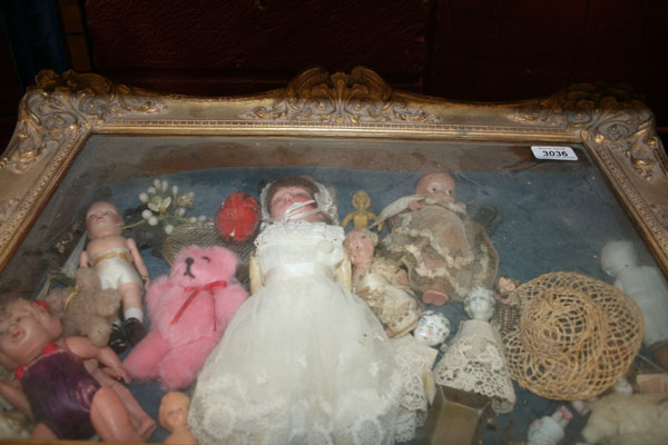 Ornate gilt framed glass fronted display cabinet, containing miniature and small dolls, celluloid,