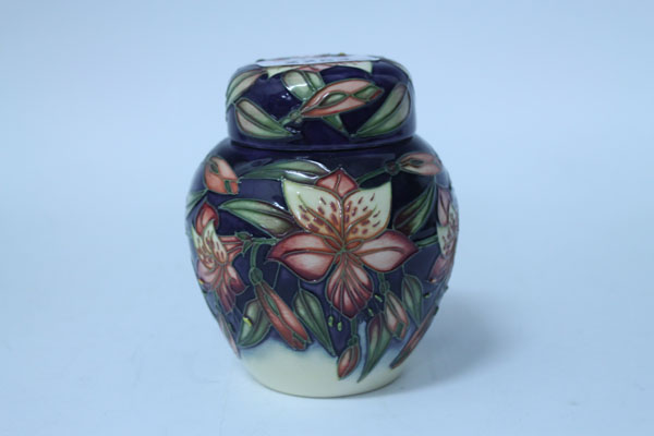 Moorcroft pottery ginger jar and cover with floral decoration on purple and cream ground, printed