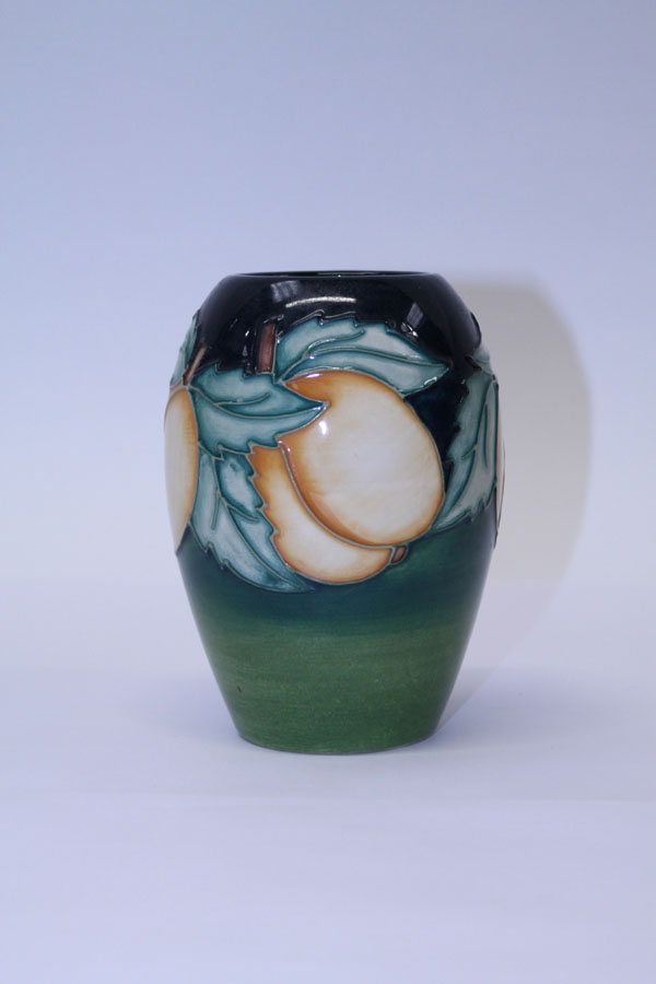 Moorcroft pottery vase decorated in the Lemon pattern on blue and green ground, dated 96, 13.5cm