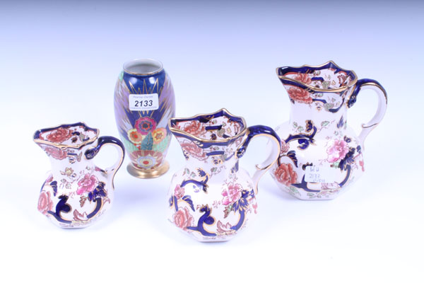 Carlton Ware vase with floral decoration on blue and gilt ground, 15.5cm high and set of three