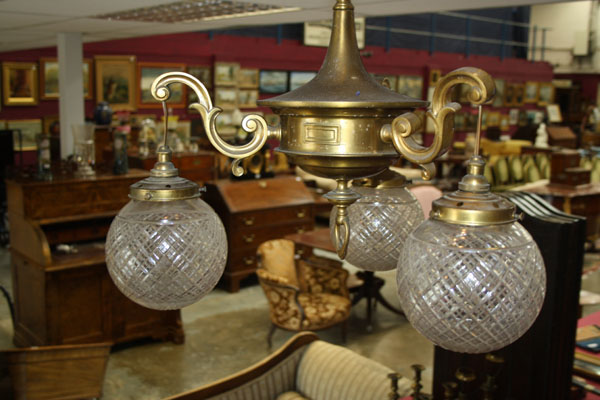 Edwardian brass three-branch chandelier with three cut glass shades and a pair of brass wall