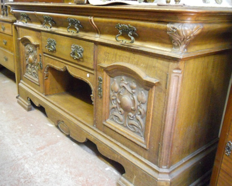 A 6’2” Victorian oak sideboard with broken pediment and swag of fruit carving, three frieze