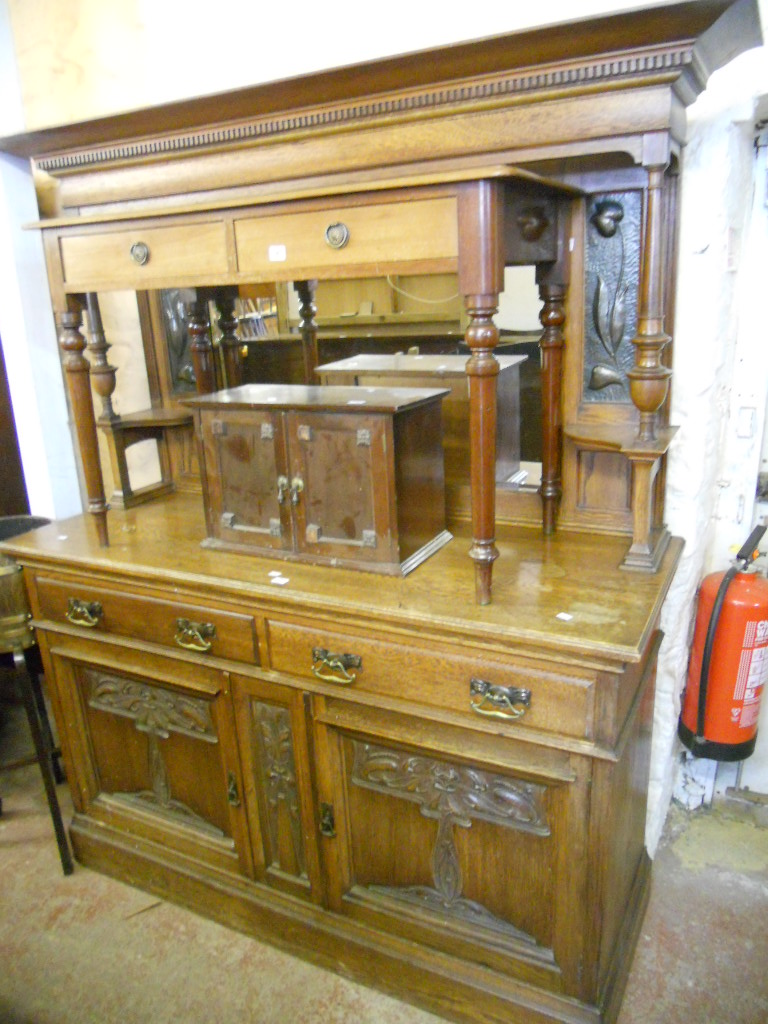 A 5’ Art Nouveau mirror backed sideboard with flanking beaten copper panels over two drawers and two