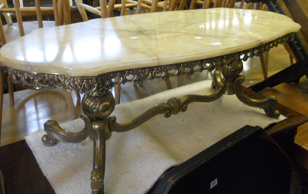 A shaped onyx table on gilt metal base