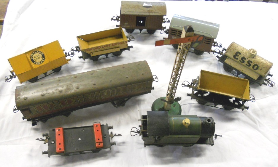 A small collection of Hornby ‘O’ gauge rolling stock, flag signal and GWR clockwork loco, (a/f)