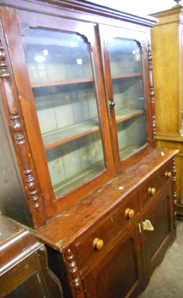 A 4’6” Victorian stained pine dresser with glazed top and two drawers, two cupboards under and