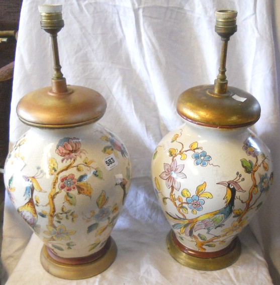 A pair of crackle glazed bulbous vase table lamps, with painted perching bird decoration