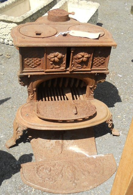 A Scottish made cast iron stove with two warming plates