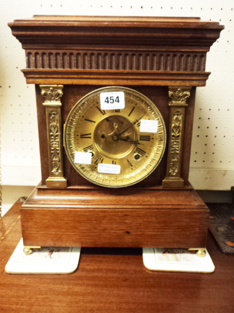 A mahogany cased mantel clock with gilt dial visible anchor escapement and Ansonia eight day