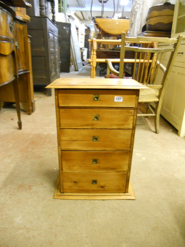 A waxed pine specimen chest of five long graduated drawers with inset brass handles