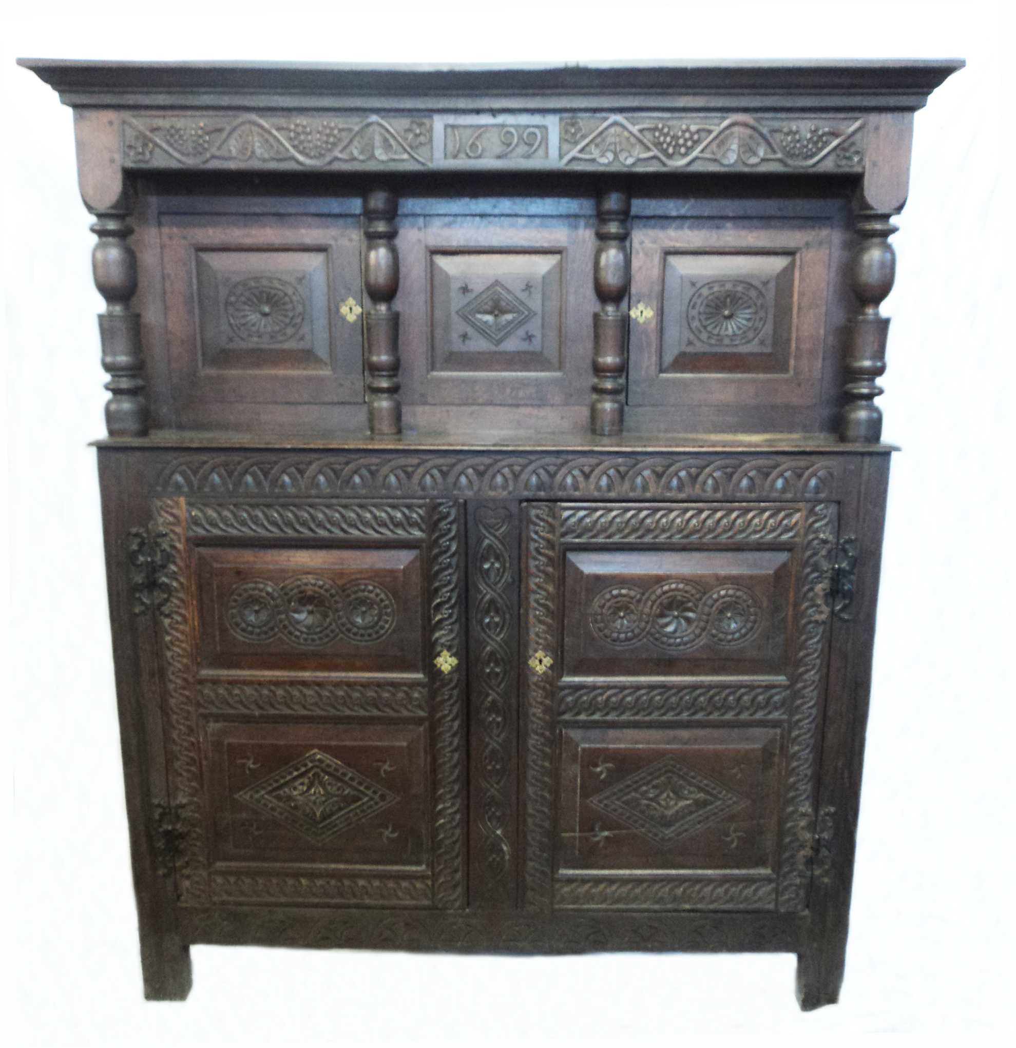 A 4’7” antique oak court cupboard with decorative carved frieze dated 1699, secret central drawers
