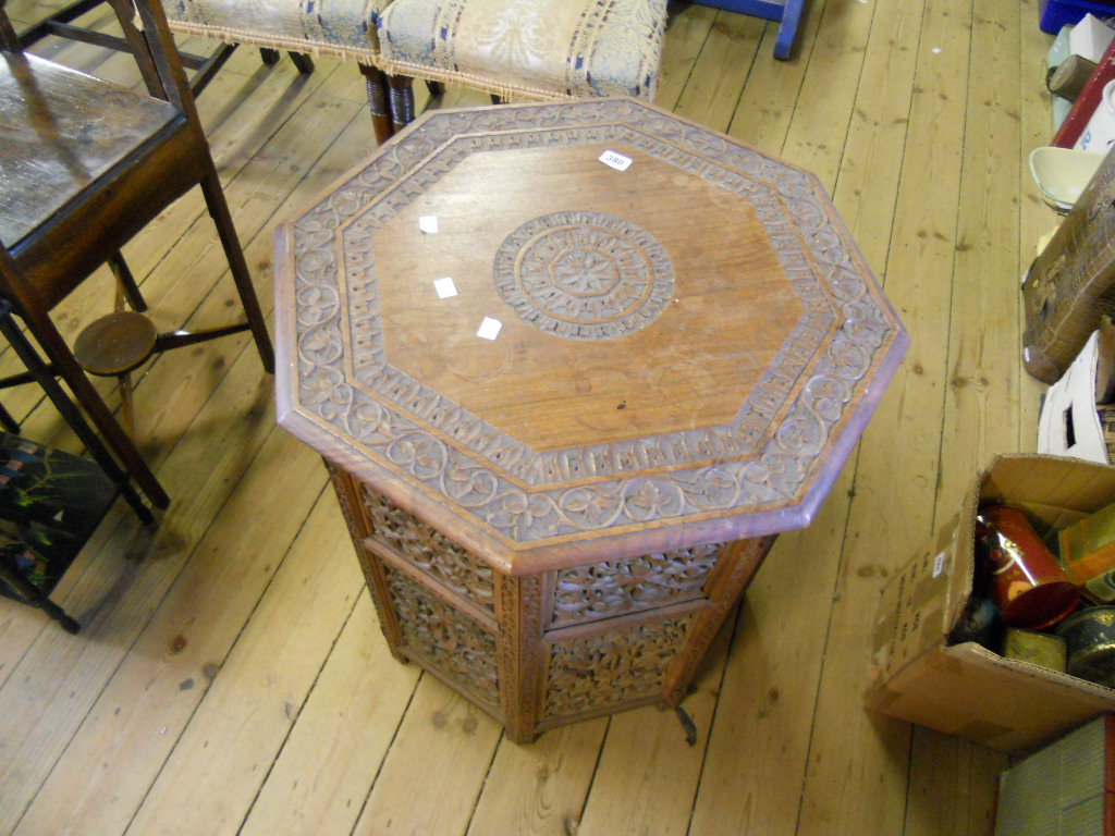 An Oriental octagonal shaped carved Moorish table with pierced foliate decoration