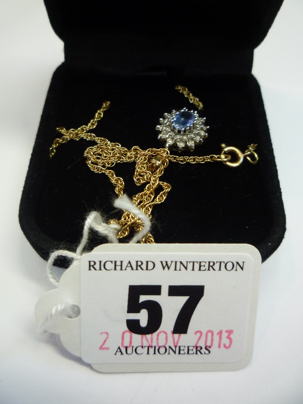 A 9CT DIAMOND AND SAPPHIRE CLUSTER PENDANT ON 9CT CHAIN