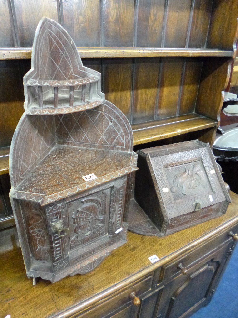 TWO SMALL CARVED OAK HANGING CORNER CUPBOARDS (s.d.)