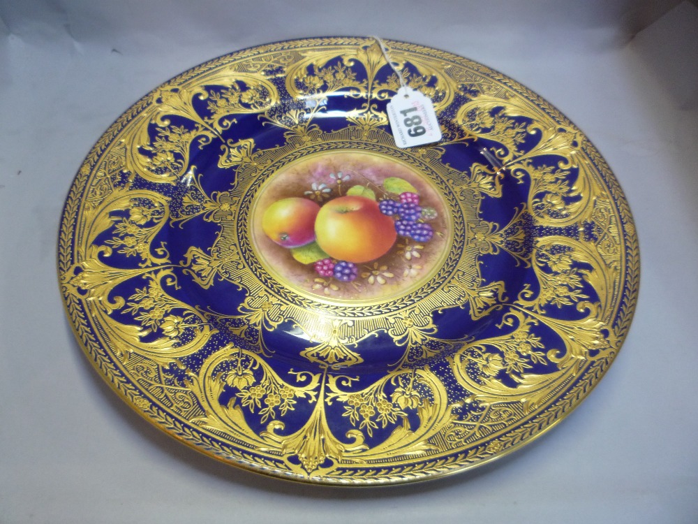 A ROYAL WORCESTER FRUIT PAINTED CABINET PLATE, signed Leaman, blue and gilt border, diameter 27cm