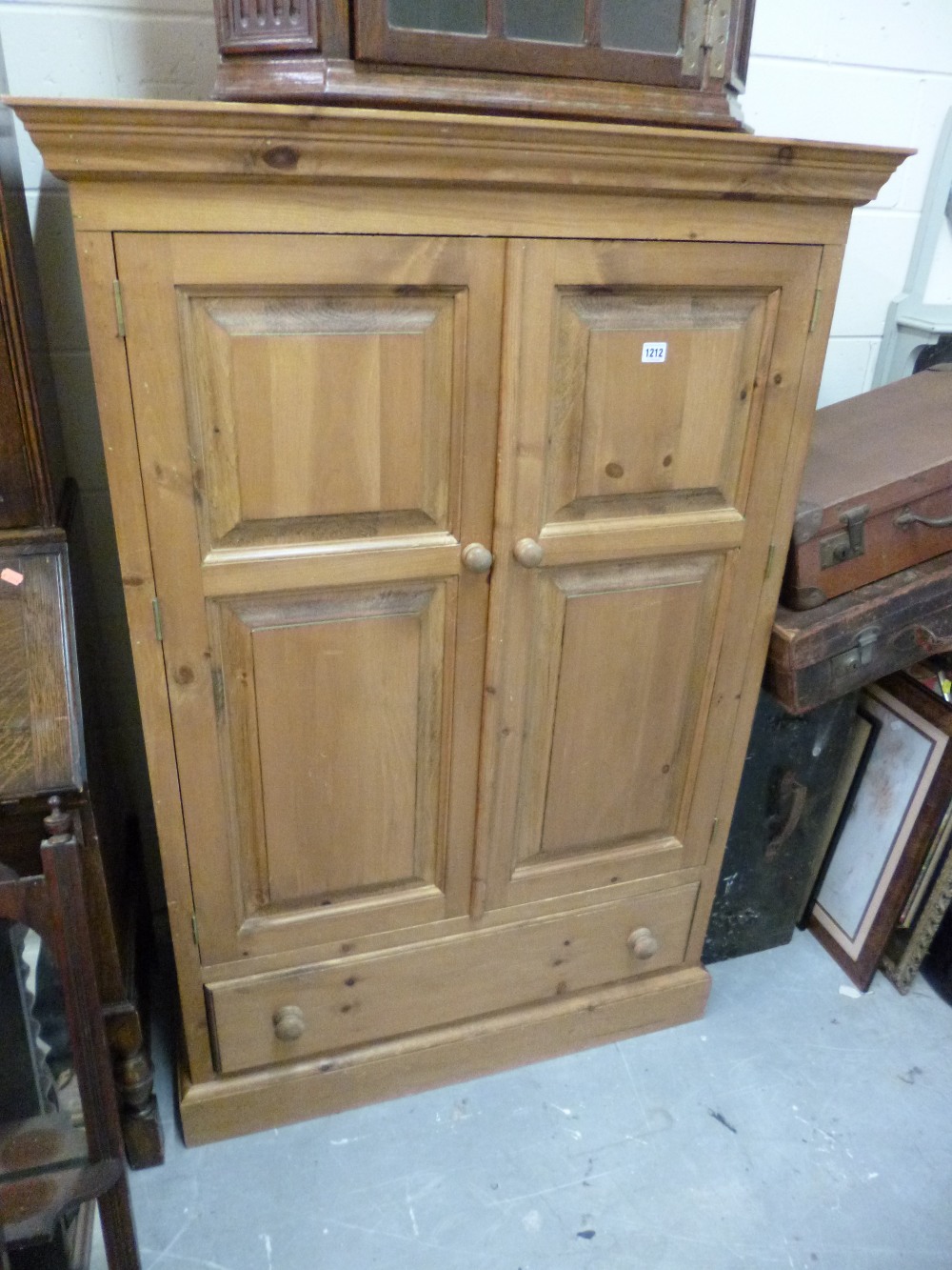 A SMALL PINE TWO DOOR WARDROBE with drawer below