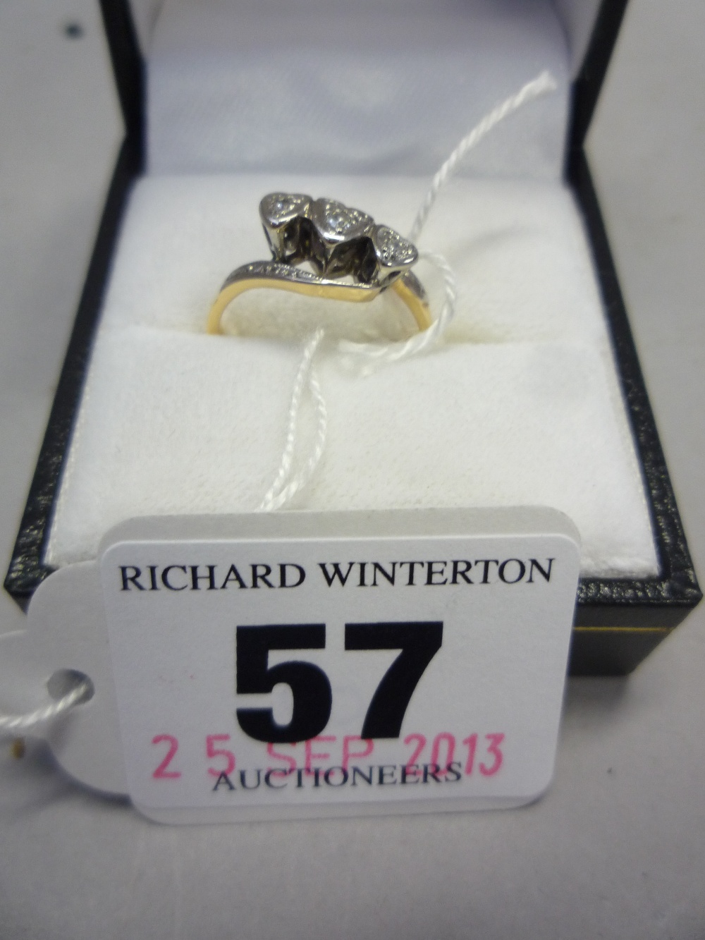 AN 18CT THREE STONE DIAMOND HEART RING