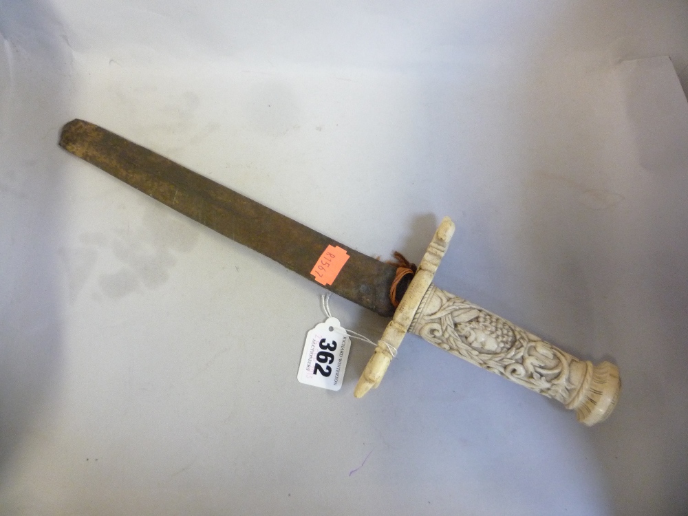 AN ANTIQUE DAGGER WITH BONE HILT, carved in high relief with a bust of a bearded gent and