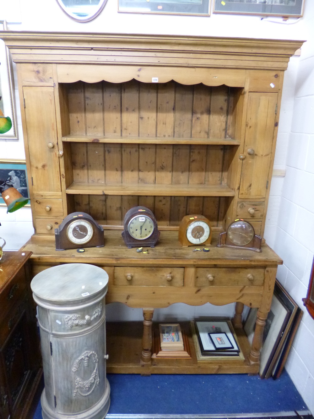 A PINE KITCHEN DRESSER with various shelves, cupboards and drawers
