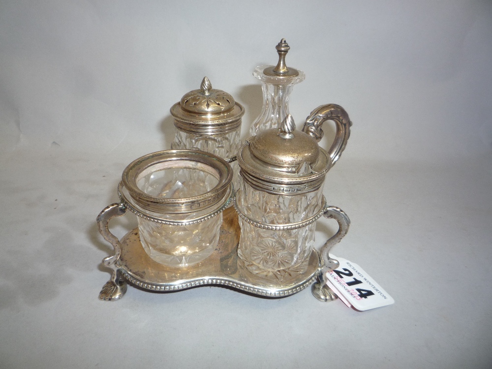 A SILVER CONDIMENT STAND, maker J.B, London 1884, four glass vessels (the stand approximately 133g)