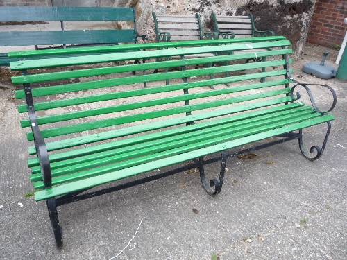 A large slatted garden bench with metal ends