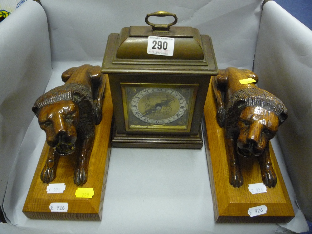 A Garrard & Co Ltd timepiece and a pair of wooden Lions (3)