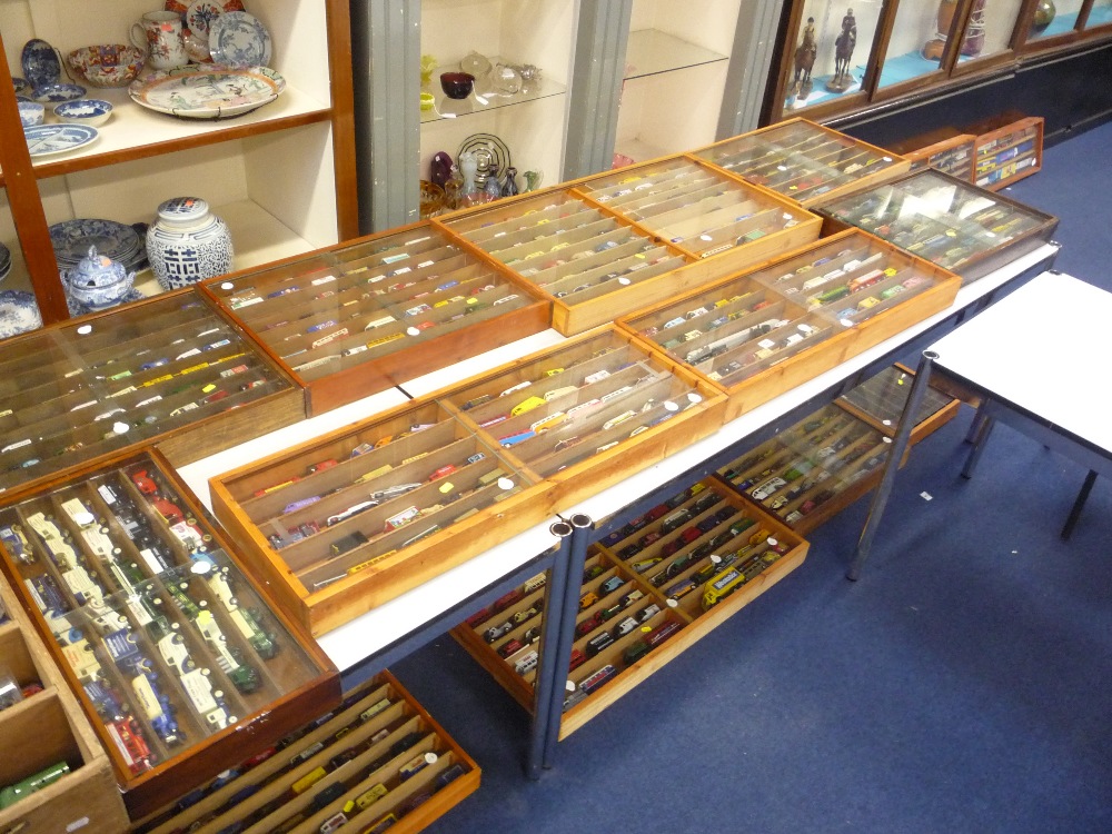 Fifteen display cases containing die-cast vehicles, a box of boxed vehicles and books and a quantity