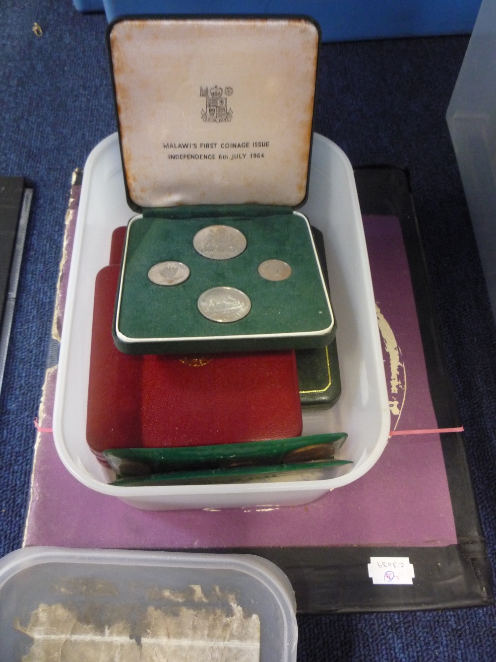 A coin album and plastic tub containing World coins several in low Denomination silver 19th and 20th