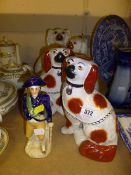 A pair of seated Spaniels, two other Spaniels and a Staffordshire figure (5)