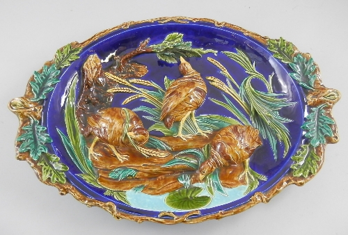 A Sarreguemines majolica charger depicting game birds, 19th century, of shaped oval form and