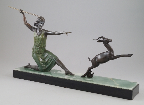 An Art Deco style painted spelter model of Diana the Huntress on faux marble base, standing full