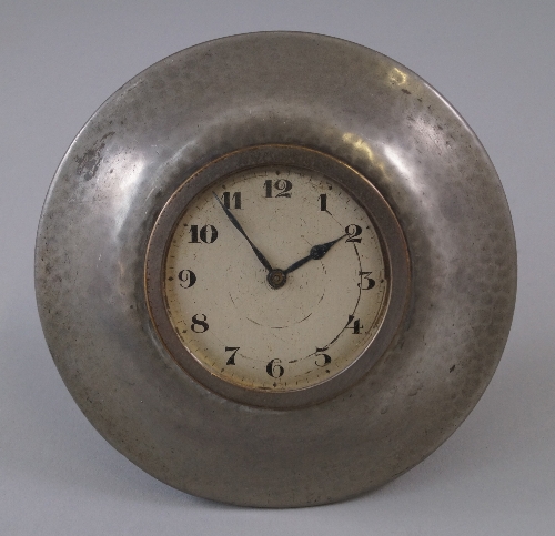 A Liberty & Co Tudric pewter circular desk clock, c.1915, of planished decoration around circular