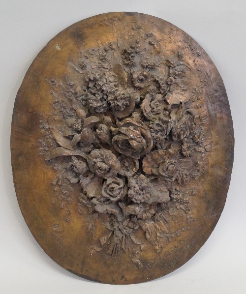 A French bronze oval wall plaque, c.1876, overall decorated with bouquet of flowering foliage in