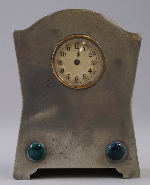 A pewter Arts and Crafts mantel clock, probably Liberty & Co Tudric, c.1905, of shaped rectangular