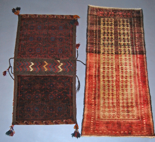An Afghan saddlebag, the two panels with star motifs in a deep claret coloured field, 128 x 68 cm