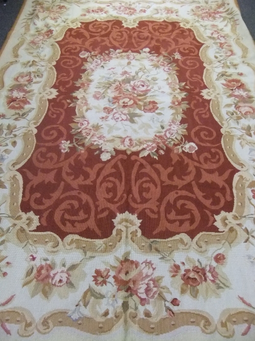 An Aubusson style rug of floral design, in shades of cream, pink and russet, 243cm high x 165cm
