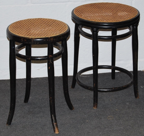 Michael Thonet, A near pair of ebonised bent-wood stools, having caned seats, on splayed legs.