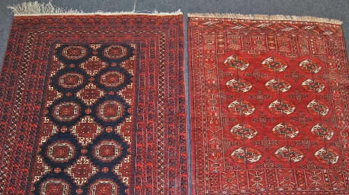 An Afghan part silk Bokhara rug, the blue ground field decorated elephant pad and lozenge motifs,